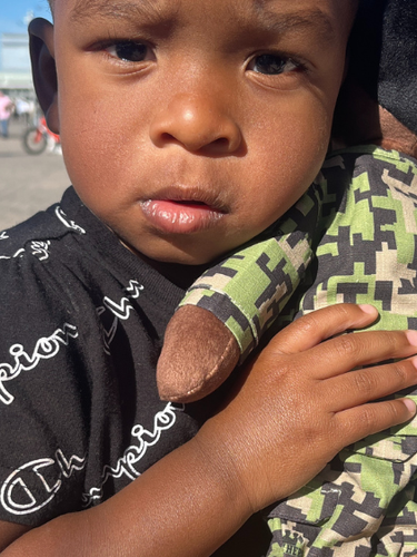 Young child hugs Daddy Doll