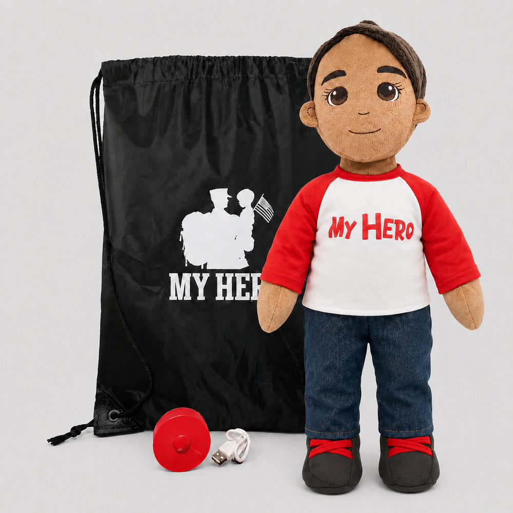 A plush doll dressed in a red and white raglan shirt with 'My Hero' printed in red, blue jeans, and dark shoes, standing beside a black drawstring bag with a white soldier graphic and 'MY HERO' text, plus a small red helmet and white cord on a light gray background.