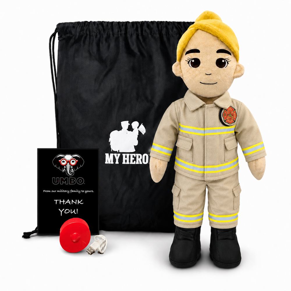 A firefighter-themed plush doll stands in front of a black drawstring bag with a white 'MY HERO' graphic, next to a small black card that reads 'UMBO. How are we doing? Feeling good, THANK YOU!' and a red fire hydrant, all on a white background.