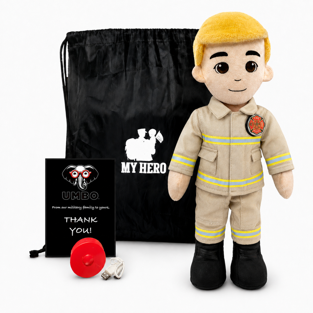 A firefighter-themed plush doll stands in front of a black drawstring bag, with a small black thank-you card and a red fire hydrant accessory on a white studio background. The doll wears a tan uniform with yellow reflective stripes, black boots, and a yellow hair color.