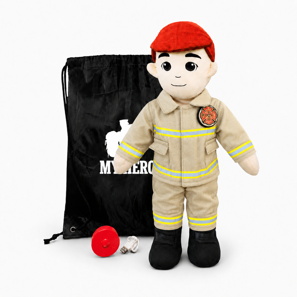 A plush firefighter doll wearing a beige turnout-style uniform with yellow reflective stripes, a red beret, and black boots, standing in front of a black drawstring bag with white text. A red helmet and a small silver accessory lie on the floor in front, all on a light gray studio background.