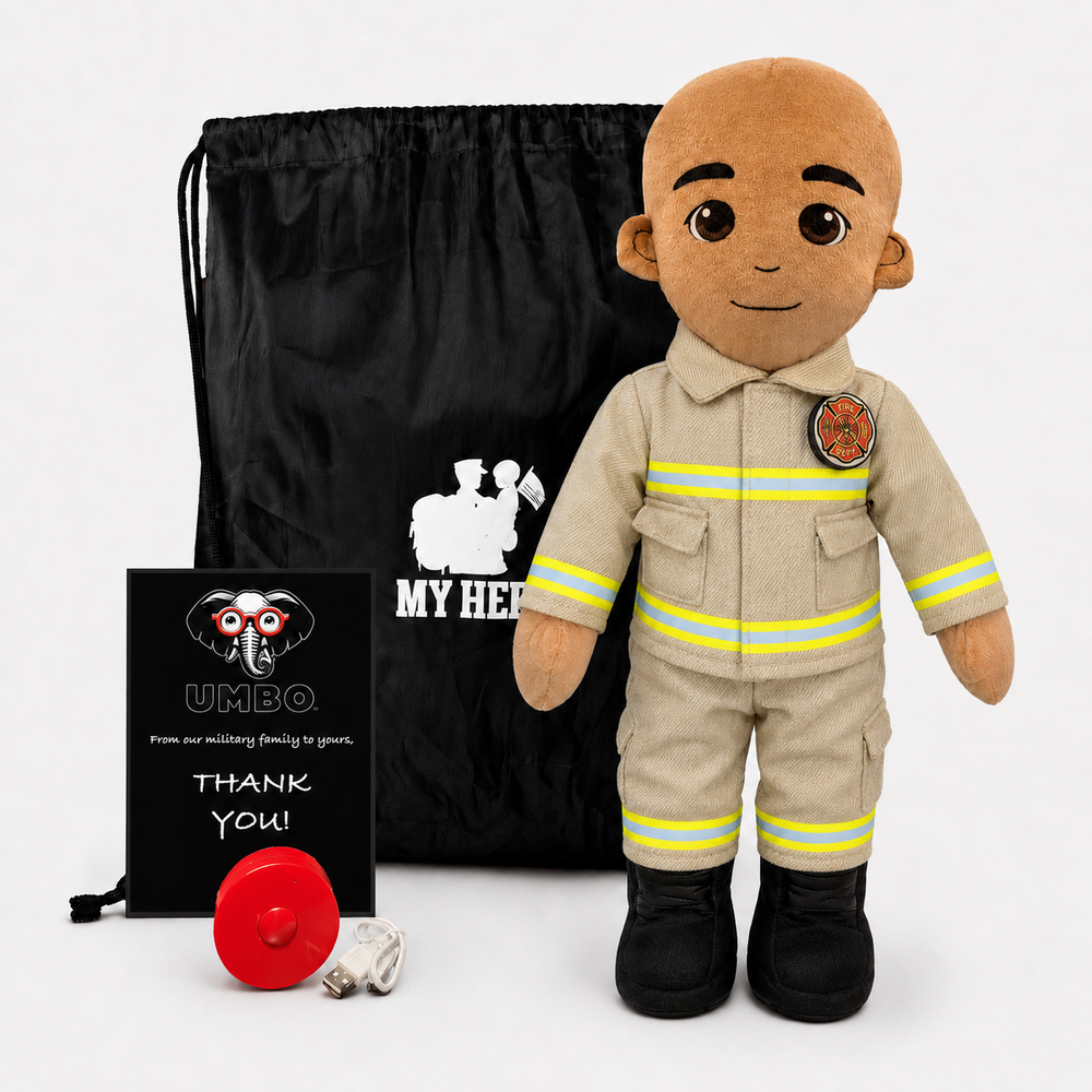 A firefighter-themed plush doll stands in front of a black drawstring bag, with a black card reading 'UMBO' and a red hose coil on a white studio background.
