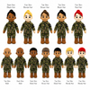 Navy Daddy Doll Plush figures arranged in two rows on a white background, each wearing a green camouflage military-style uniform and brown boots. The dolls vary in skin tone, hair color, and hair style, with labels above and below indicating combinations such as Dark Skin Black Hair, Fair Skin Blonde Hair, Tan Skin Brown Hair, and Fair Skin Red Hair.