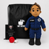 Paramedic Doll with tan skin and brown hair, female emergency responder in a blue EMT uniform with black boots beside a black My Hero drawstring bag, recorder and accessories on a white background.