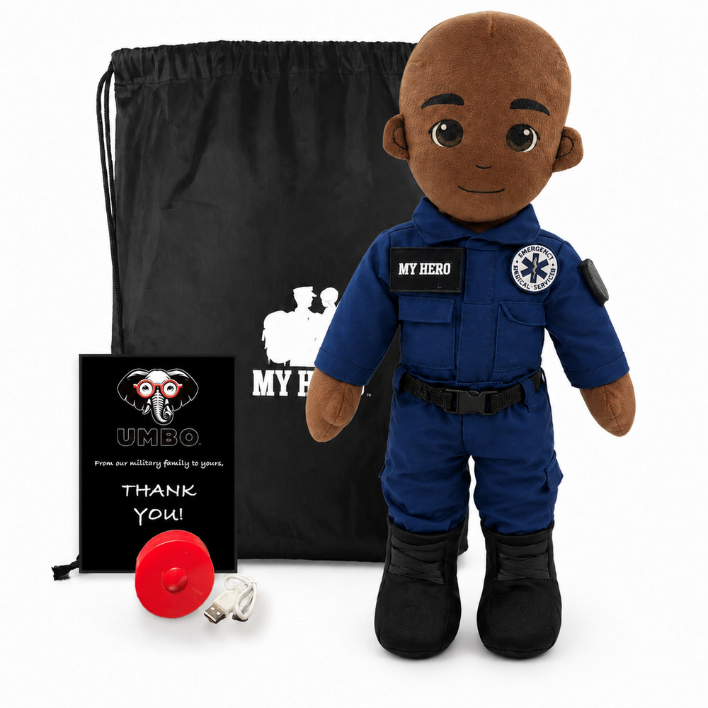 Emergency Responder Doll with dark skin and a bald head, male paramedic wearing a blue EMT uniform with black boots beside a black My Hero drawstring bag, recorder and accessories on a white background.