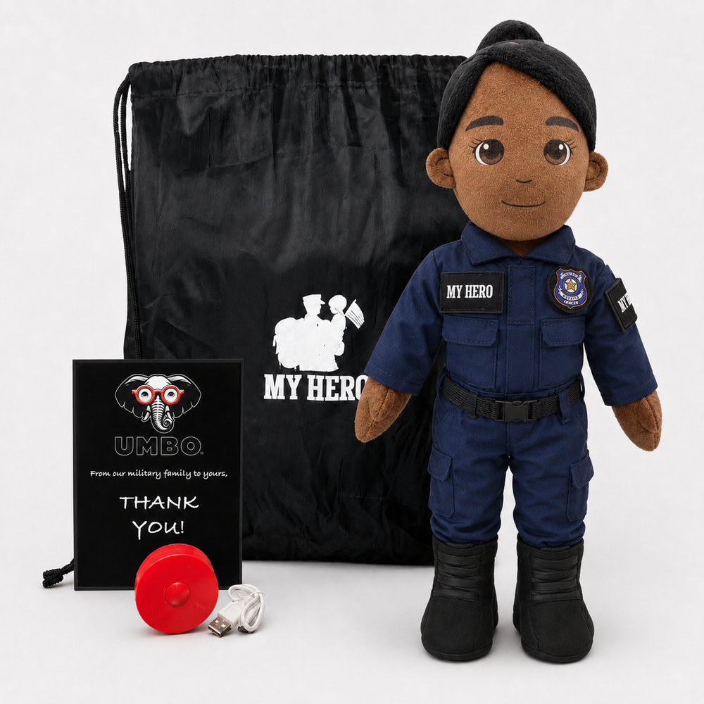 A Police doll dressed as a police uniform stands next to a black drawstring bag, a black card reading 'UMBO. From our military family to yours, THANK YOU!', and a small red ribbon on a light gray background.