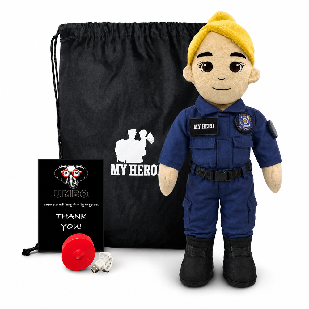 Police Officer Plush doll stands in front of a black drawstring bag and a small black gift card. The doll has a yellow helmet/hair, a beige face and arms, and is dressed in a blue uniform with black boots.