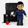 A custom plush police doll dressed in a blue  police doll uniform with a black name patch reading 'MY HERO'. The plush is displayed next to its black drawstring bag, a black printed card, and a small red accessory on a clean white background.