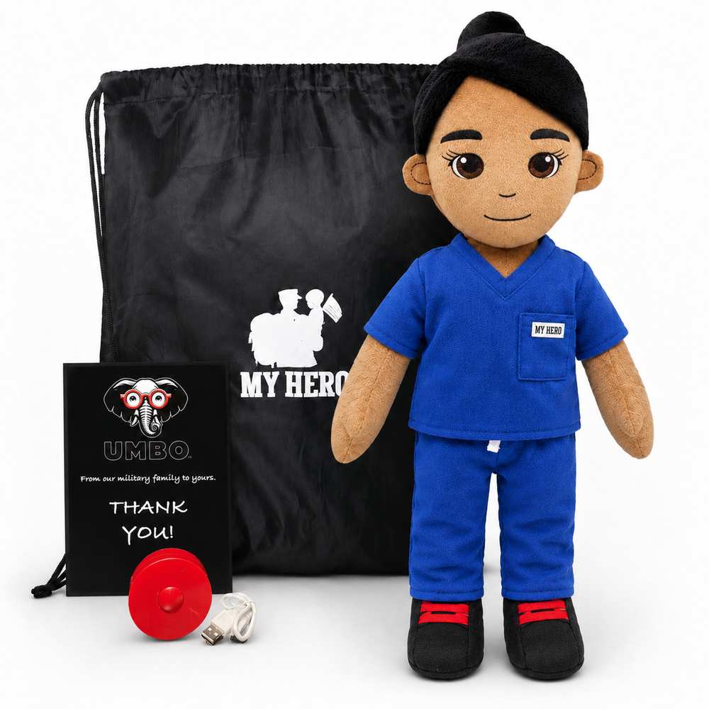 Doctor doll in blue medical scrubs with tan skin and black hair, female recordable healthcare dollA plush medical-themed doll stands in front of a black drawstring bag, with a small black card and a red circular accessory on a white studio background. The doll has dark hair, brown skin, and wears a blue scrub top and pants with black shoes and red accents.