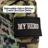 Close-up of Daddy Doll in camouflage next to a patch labeled "MY HERO" — customizable recordable plush designed for emotional support during deployment.