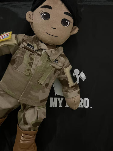 Plush toy in military uniform with a patch, standing against a black background with text.