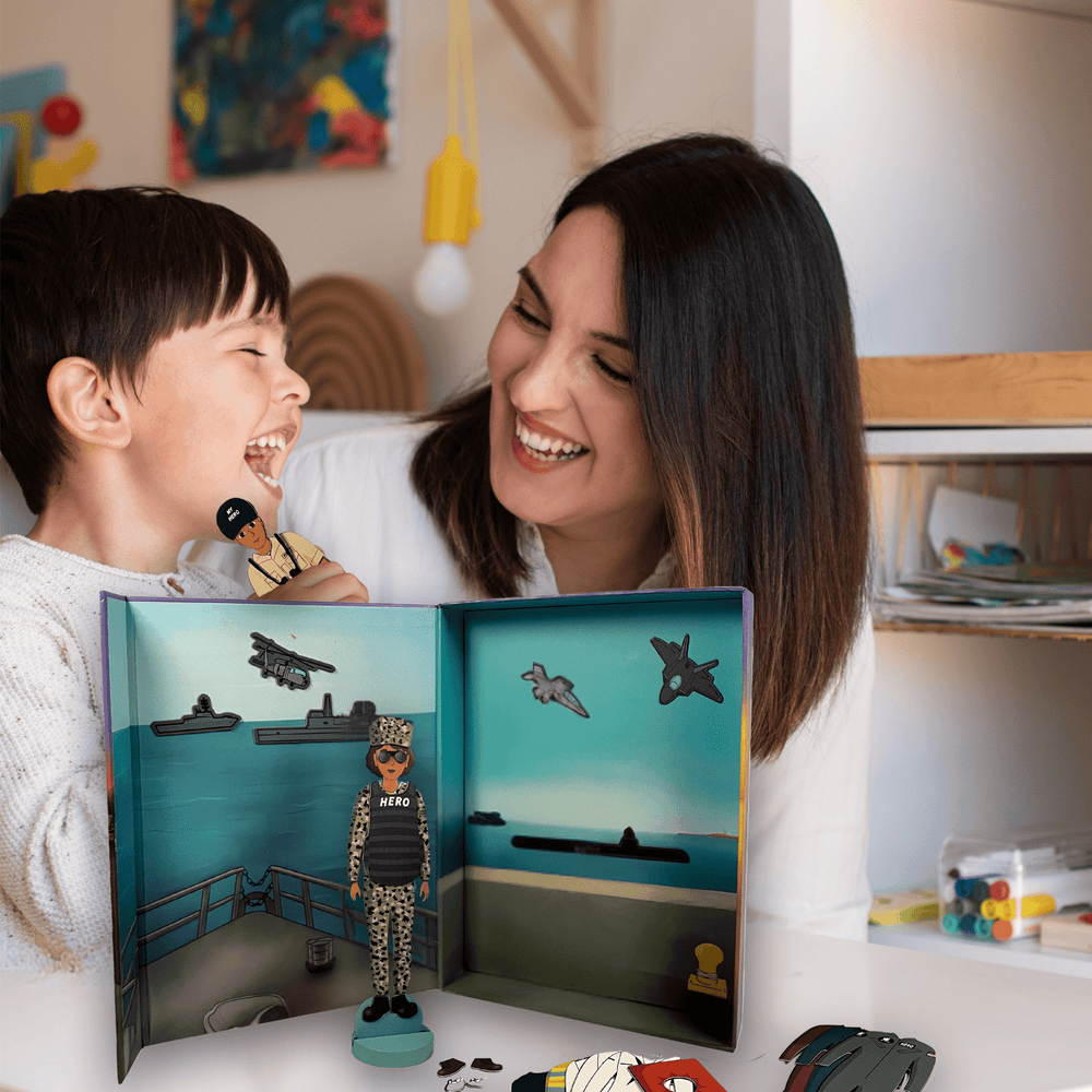 Two children smiling while playing with MY HERO Magnetic Doll Set — a screen-free, hands-on activity for kids to explore military family life creatively.