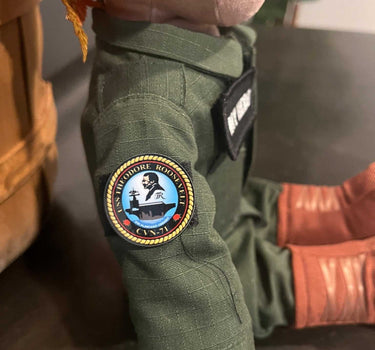 USS Theodore Roosevelt CVN-71 flight suit patch on MY HERO Sailor doll, featuring a high-quality vinyl sticker and Velcro backing.